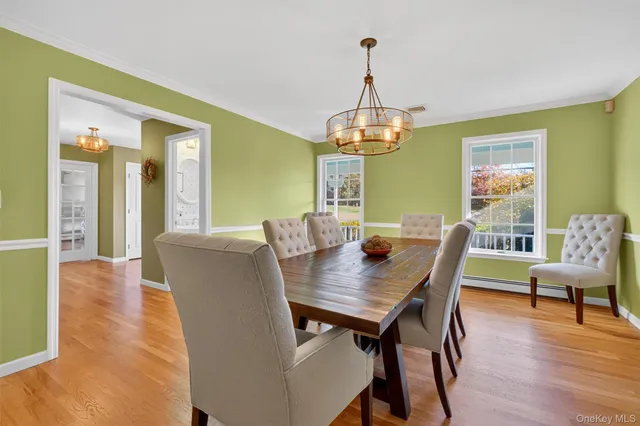 a view of a dining room with furniture wooden floor and chandelier