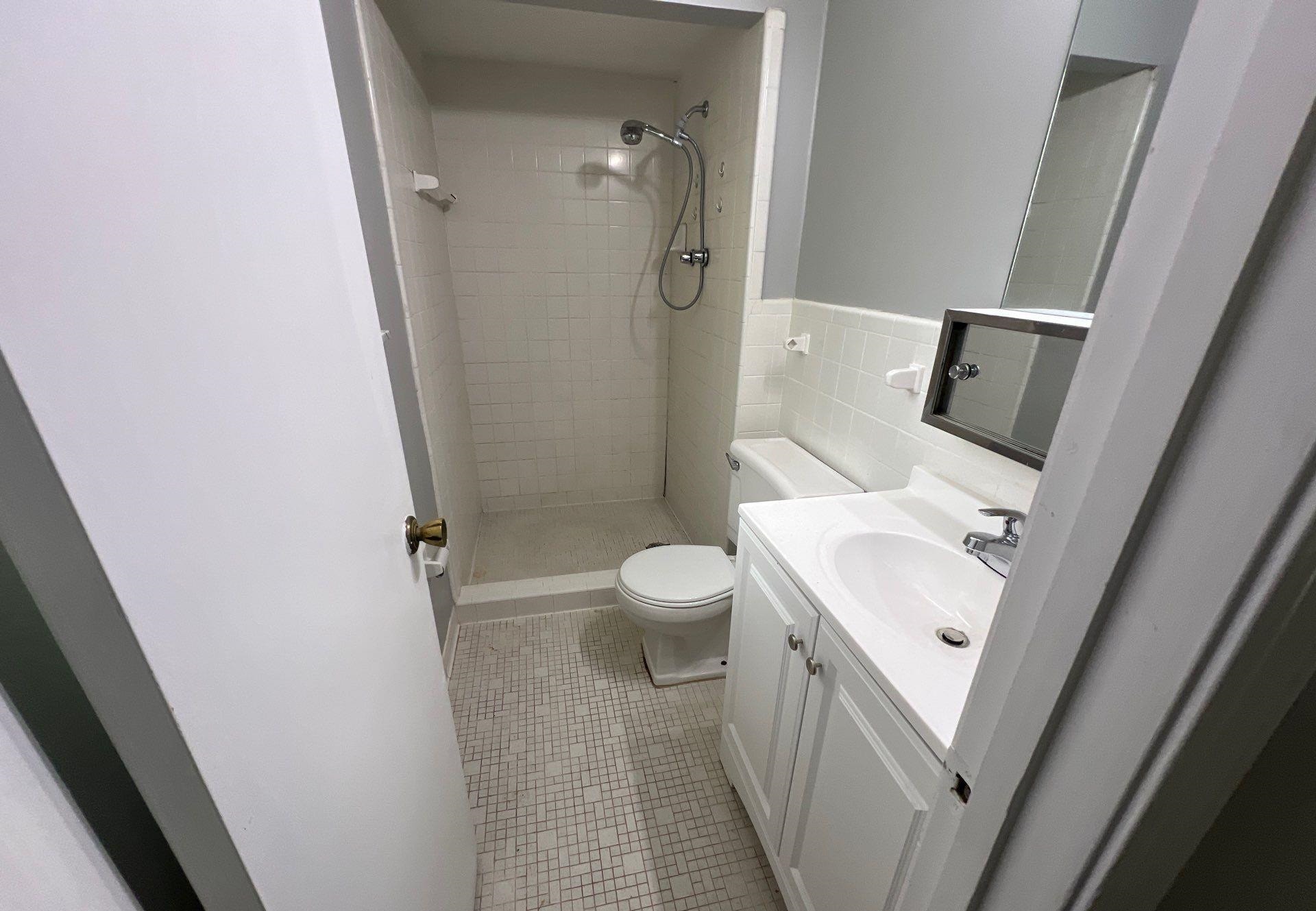 4936 Warrington Road Memphis, TN 38118 - Photo 7 of 13 a bathroom with a sink a toilet and shower