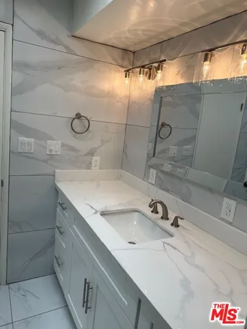 a bathroom with a sink and mirror