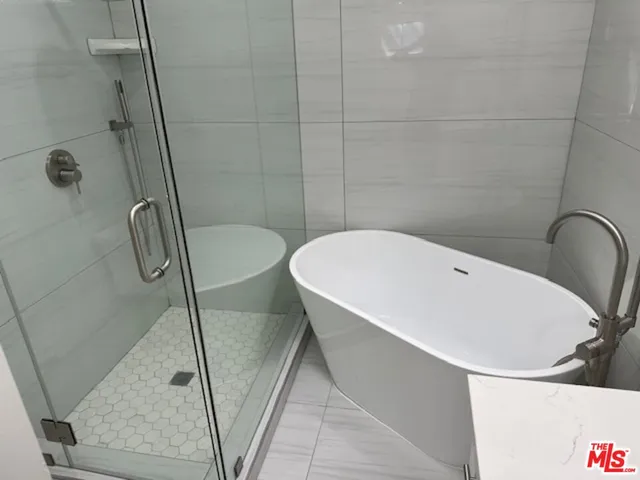 a white bath tub sitting next to a shower