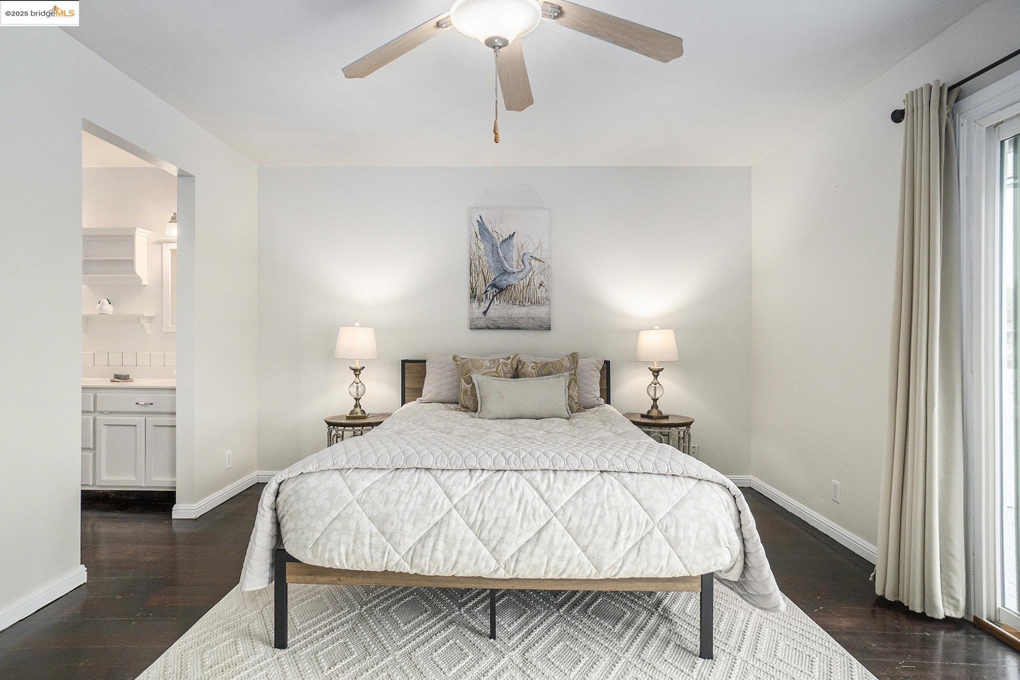 870 Willow Lake Road Discovery Bay, CA 94505 - Photo 16 of 39 a bedroom with a bed and a chandelier