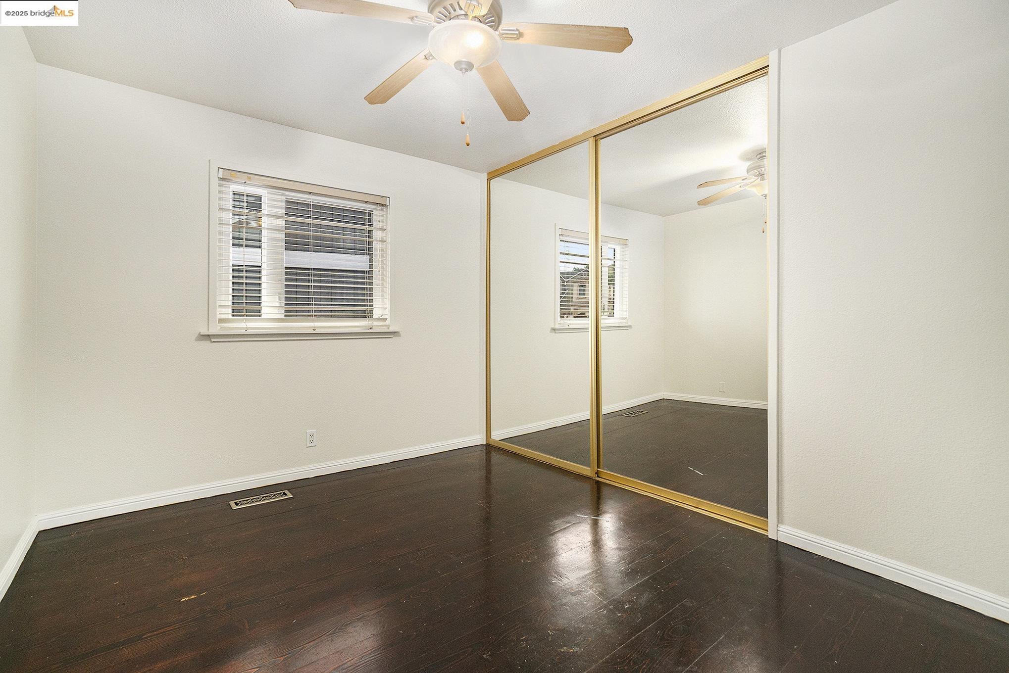 870 Willow Lake Road Discovery Bay, CA 94505 - Photo 19 of 39 a view of an empty room with a window and wooden floor