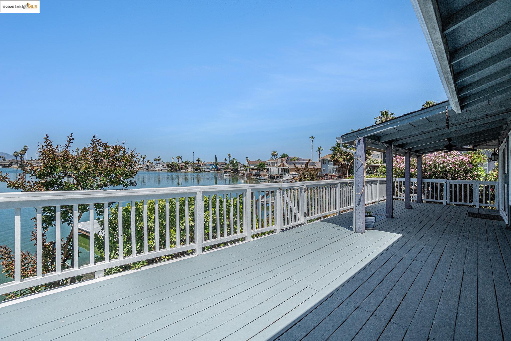 870 Willow Lake Road Discovery Bay, CA 94505 - Photo 28 of 39 a view of a balcony with wooden floor and outdoor seating
