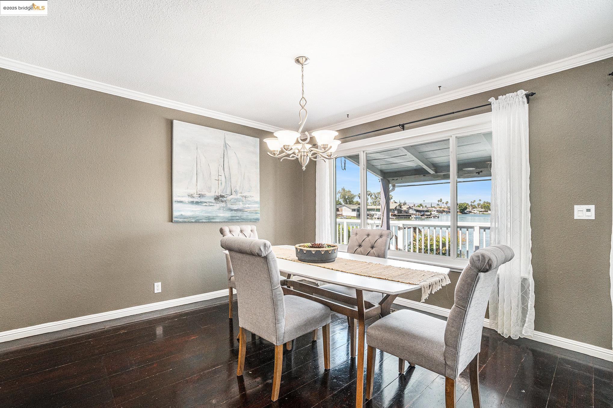 870 Willow Lake Road Discovery Bay, CA 94505 - Photo 10 of 39 a dining room with furniture a chandelier and wooden floor