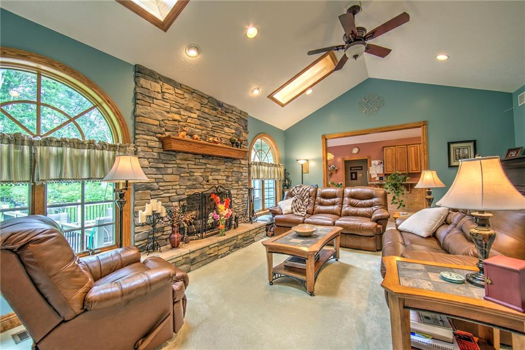 2857 Winner Road Clark, PA 16113 - Photo 11 of 25 The 24x15 Living Room features skylights, ceiling fans, a stone fireplace and two large windows bringing the outside into the comfort of you home on those chilly nights.