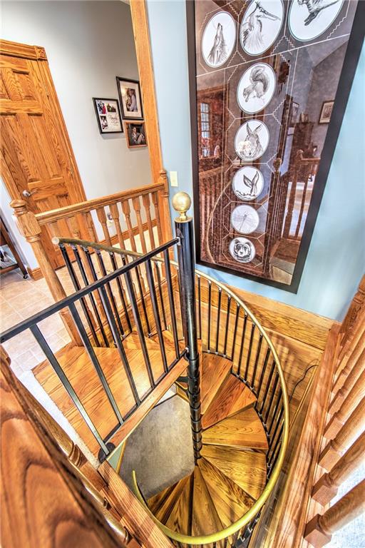 2857 Winner Road Clark, PA 16113 - Photo 19 of 25 Spiral staircase leading from the first floor to lower finished level. There is also a wide walk up stairway to the garage for easy furniture moving. If needed, this stairway could be removed and an elevator installed.