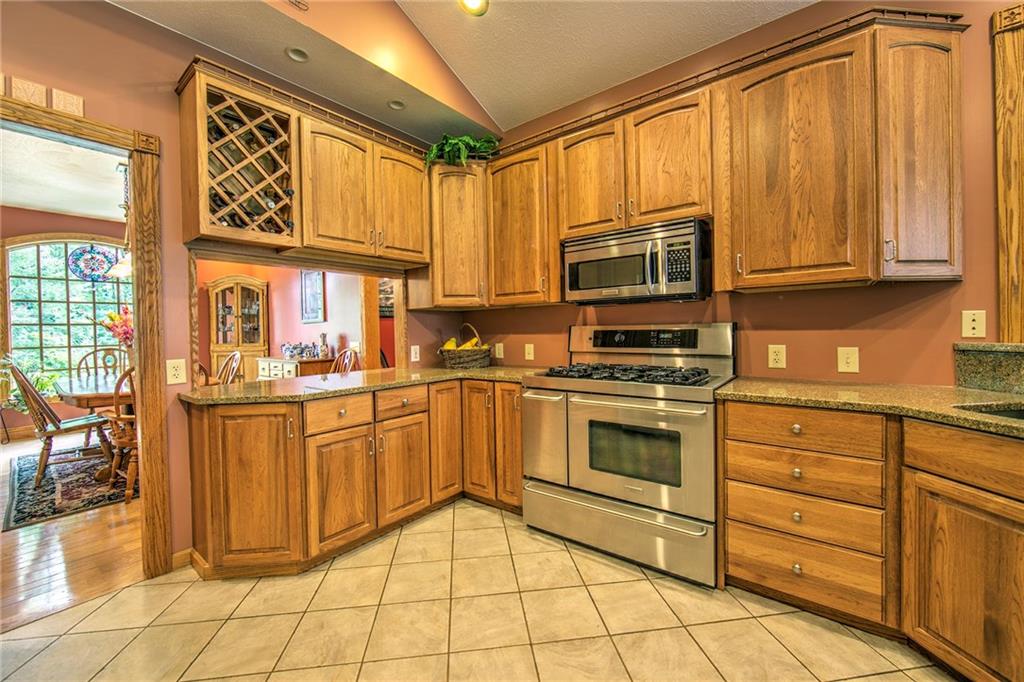 2857 Winner Road Clark, PA 16113 - Photo 6 of 25 23x12 Hickory Kitchen with convenient pass thru counter space to the dining room. The appliances are Frigidaire Professional Series Stainless Steel. Kitchen also features a tiled floor, plenty of granite counter tops and recessed lighting.