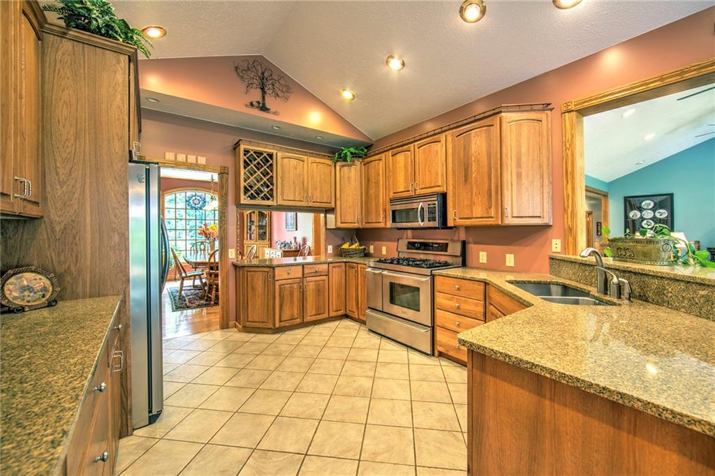2857 Winner Road Clark, PA 16113 - Photo 7 of 25 Double sink and breakfast bar with counter opening to the living room area.