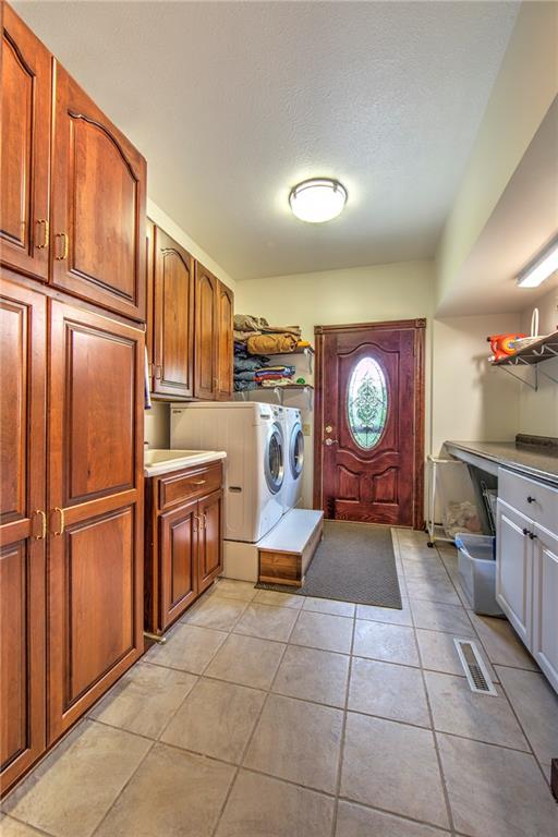 2857 Winner Road Clark, PA 16113 - Photo 10 of 25 14x8 First Floor Laundry Room/Mud Room with access to the outside and close proximity to kitchen for multi tasking. Plenty of cabinetry and counter space for folding clothes. LG Washer and Dryer included.