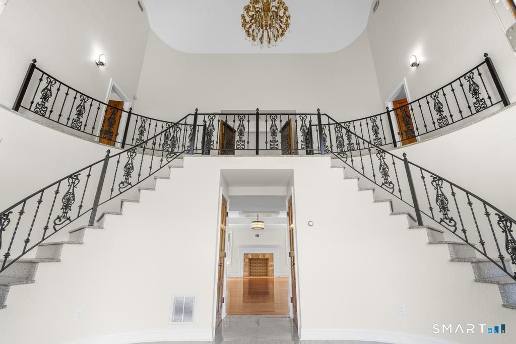 49 Partridge Lane Middletown, CT 06457 - Photo 4 of 39 a view of staircase with lots of frames on wall and white walls