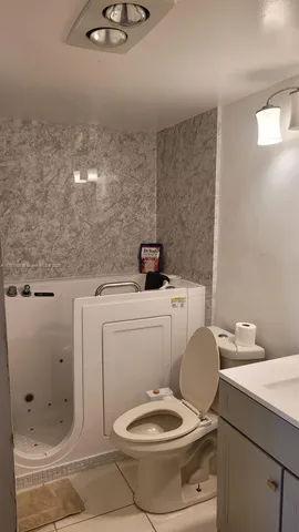 a bathroom with a toilet a sink and a mirror