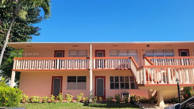 a living room with furniture a rug and a window