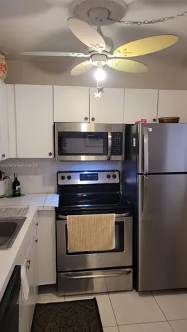 a bathroom with a granite countertop toilet a sink and a mirror
