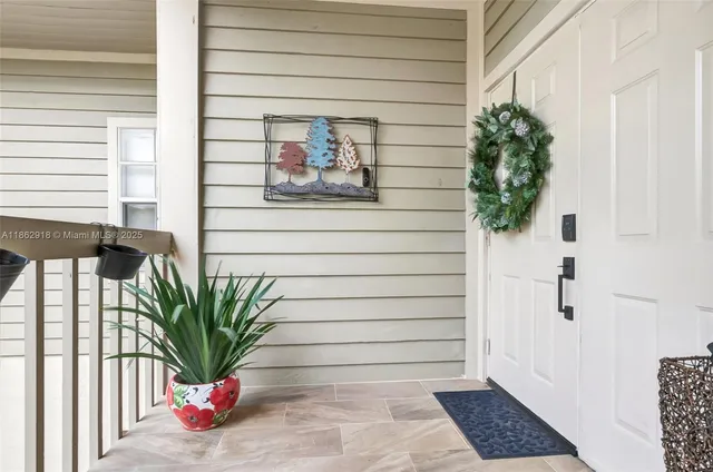 a potted plant sitting on a door and a window