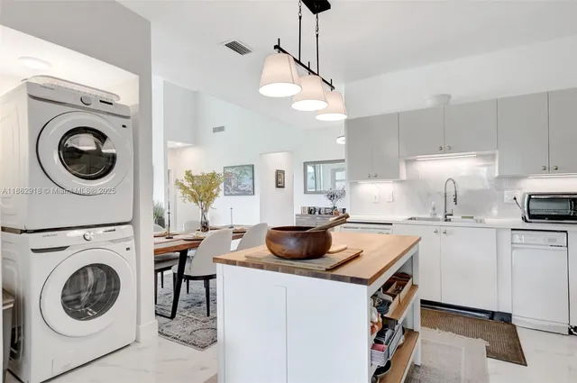a kitchen with a stove a sink and cabinets