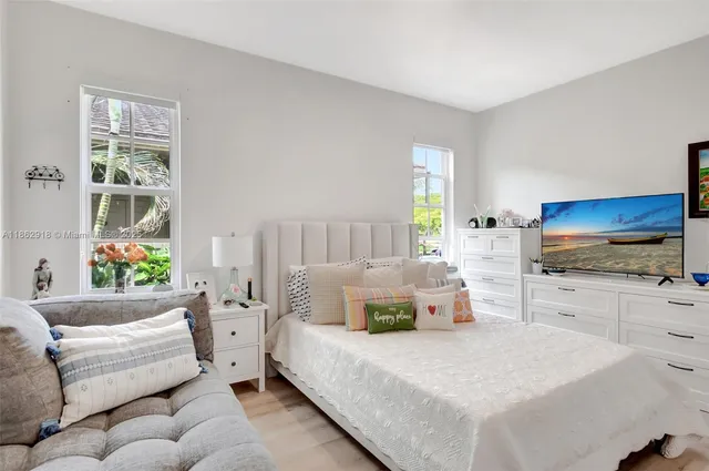 a bedroom with bed and window