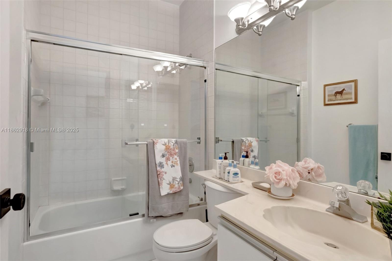 7616 Elm Ridge Drive, Unit 7U Boca Raton, FL 33433 - Photo 17 of 36 a bathroom with a sink toilet and shower