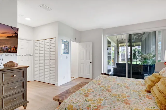 a bedroom with a bed and large windows