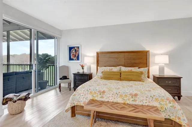 a bedroom with a large bed and a large window