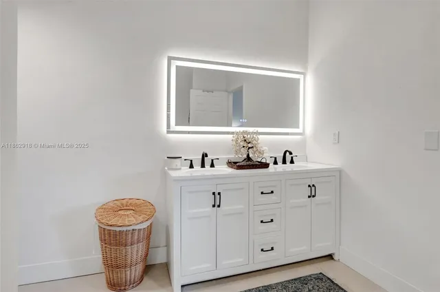 a bathroom with a toilet a sink a vanity and mirror