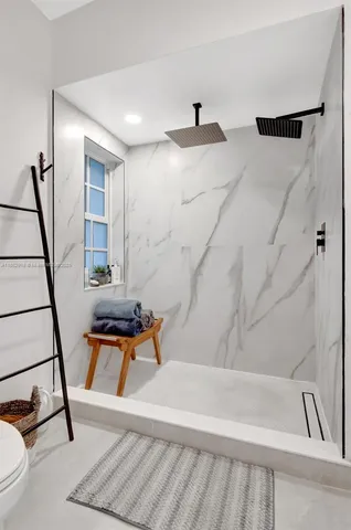 a bathroom with a bathtub and a shower