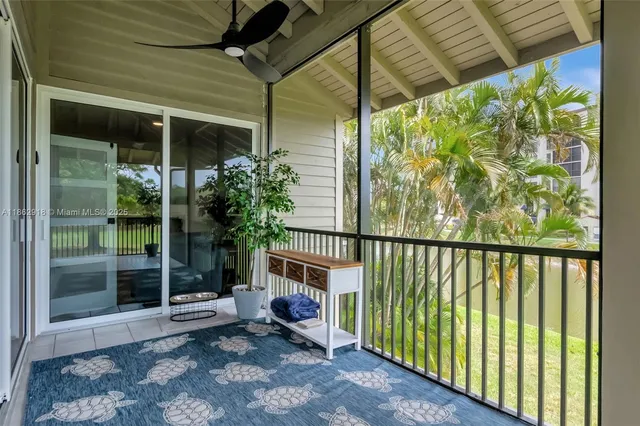 a view of a porch with a table and chairs