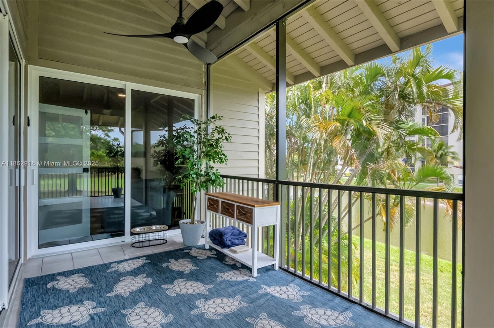 7616 Elm Ridge Drive, Unit 7U Boca Raton, FL 33433 - Photo 26 of 36 a view of a porch with a table and chairs