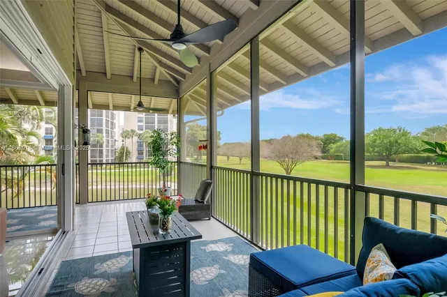 a view of a chair and tables in the balcony