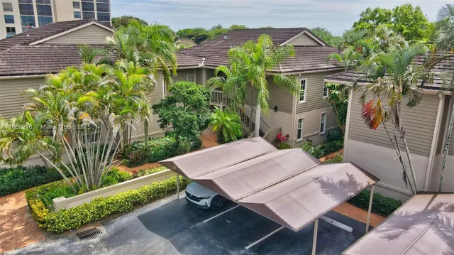 a view of a patio with table and chairs and potted plants