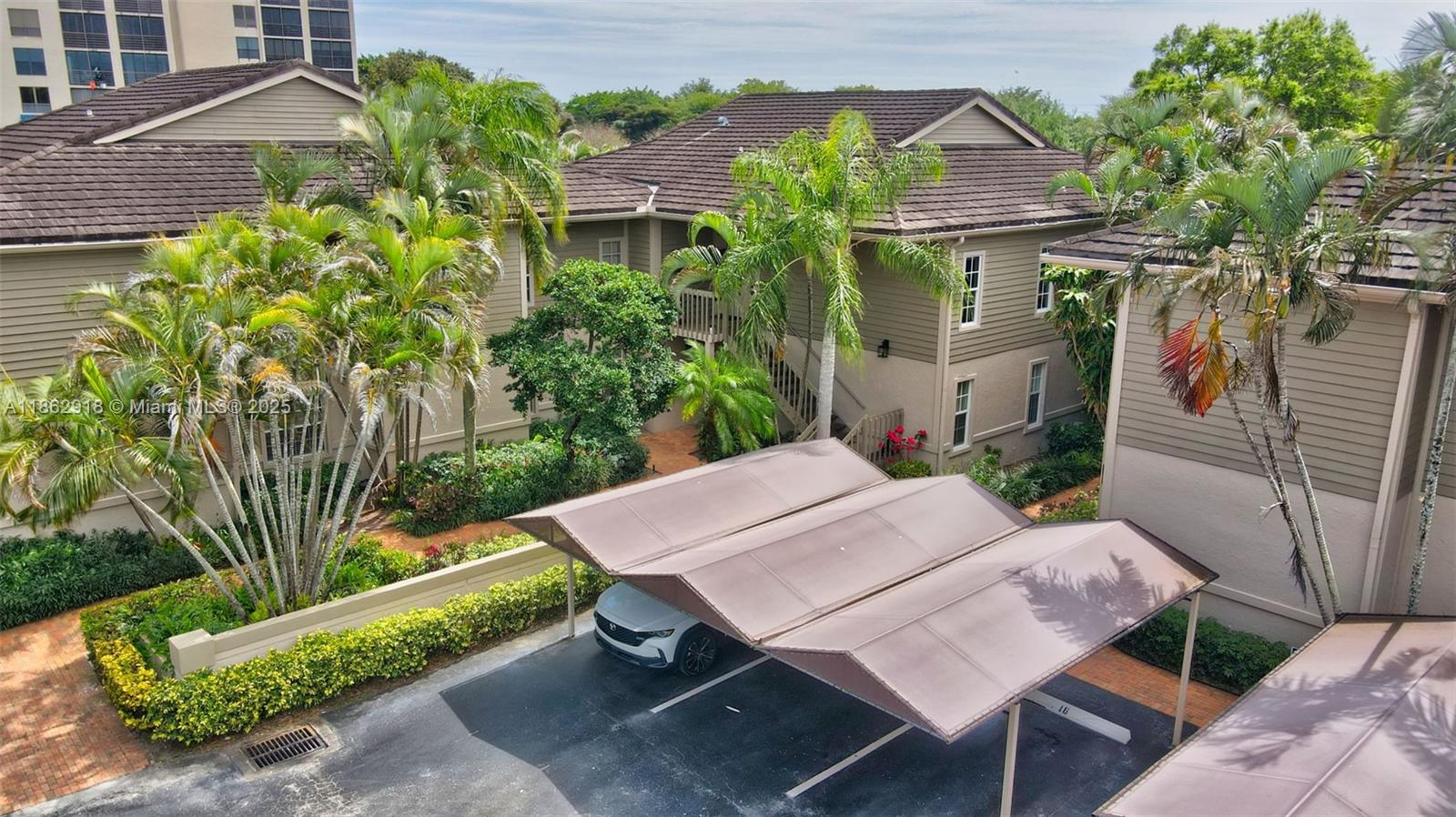 7616 Elm Ridge Drive, Unit 7U Boca Raton, FL 33433 - Photo 31 of 36 a view of a patio with table and chairs and potted plants