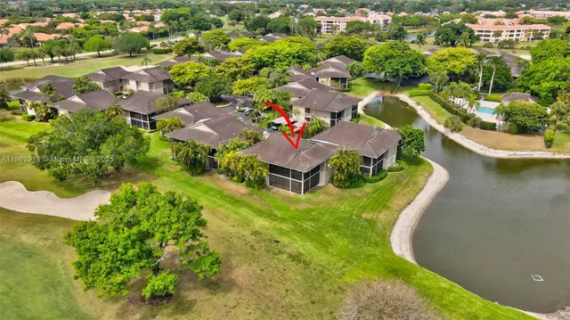 an aerial view of residential houses with outdoor space and swimming pool