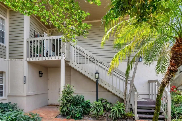 a view of balcony with small garden and wooden stairs