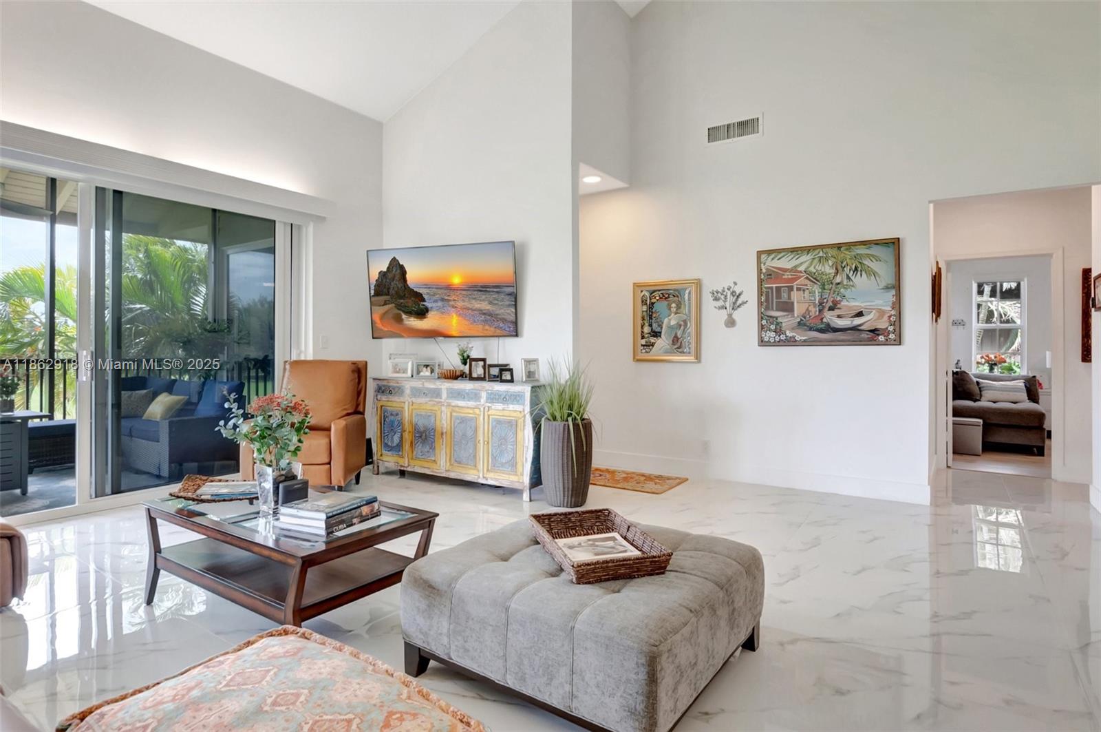 7616 Elm Ridge Drive, Unit 7U Boca Raton, FL 33433 - Photo 5 of 36 a living room with furniture and a flat screen tv