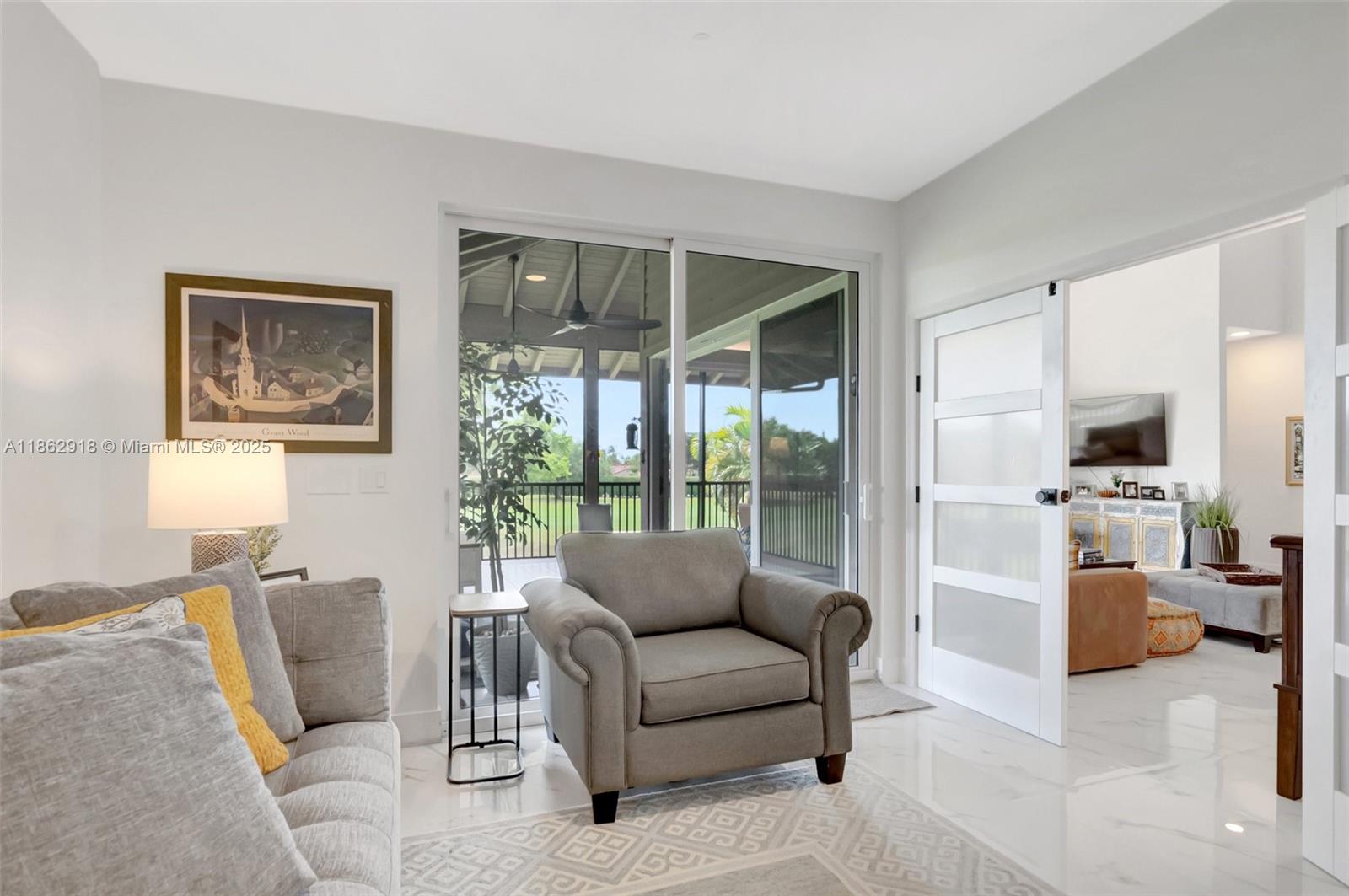 7616 Elm Ridge Drive, Unit 7U Boca Raton, FL 33433 - Photo 9 of 36 a living room with furniture and a large window