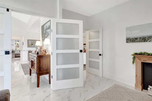 a view of kitchen with furniture and refrigerator