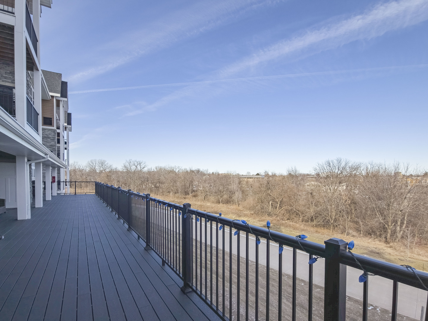 2592 Middle Road, Unit 313 Bettendorf, IA 52722 - Photo 45 of 52 a view of a balcony with wooden floor and fence