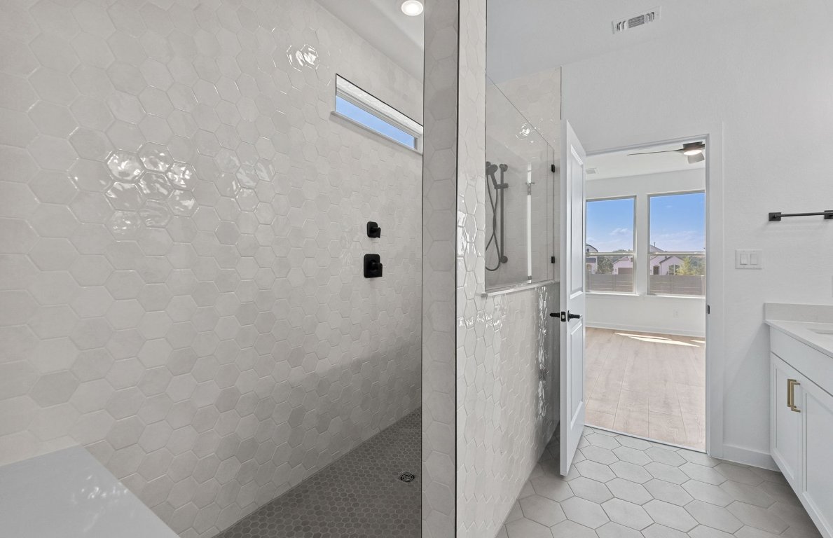1817 Spg Mountain Cove Georgetown, TX 78628 - Photo 12 of 27 a bathroom with a shower and a glass door