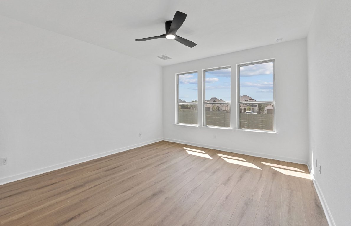 1817 Spg Mountain Cove Georgetown, TX 78628 - Photo 13 of 27 a view of an empty room with wooden floor and a window