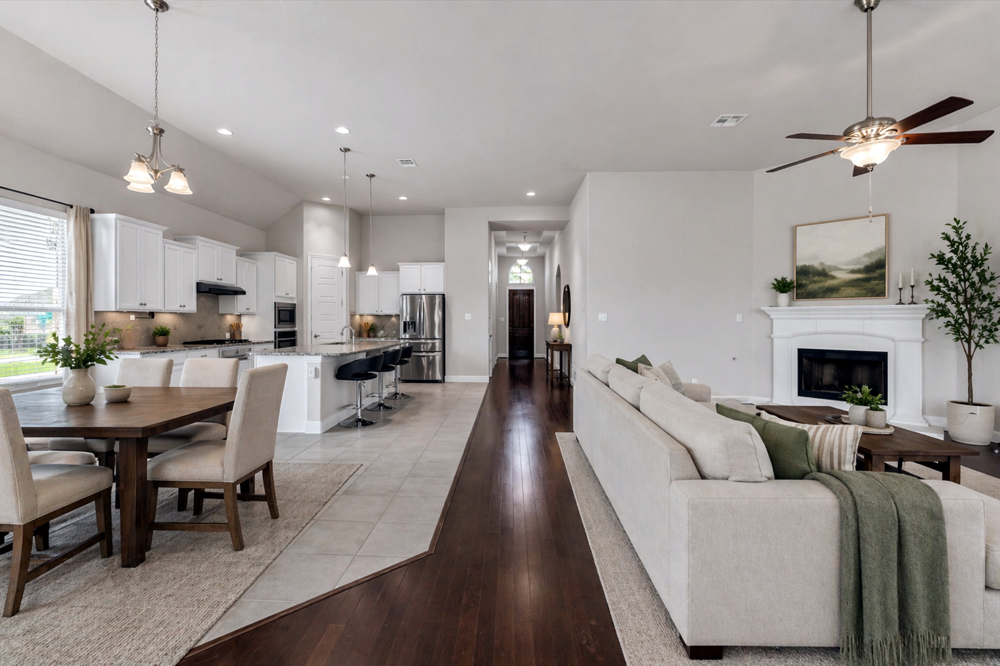 21301 Resource Road Pflugerville, TX 78660 - Photo 6 of 29 Open-concept living space featuring vaulted ceilings, wood-finish flooring, and light-toned tile
