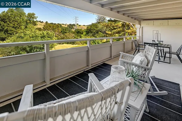 a view of a chairs and table in the balcony