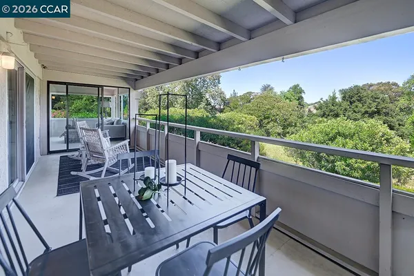 a view of yard from deck with patio