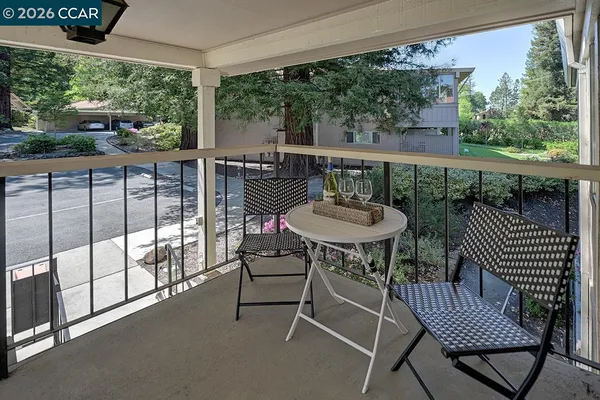 a view of a two chairs and table in the balcony