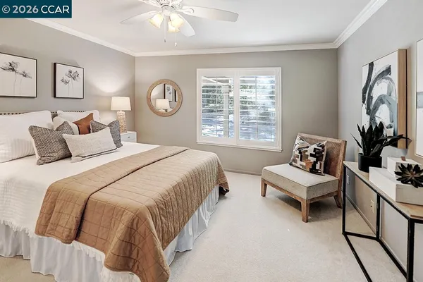 a spacious bedroom with a large bed and a chandelier