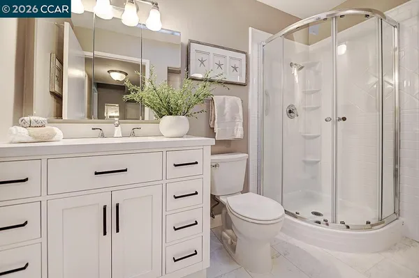 a bathroom with a sink vanity granite and toilet