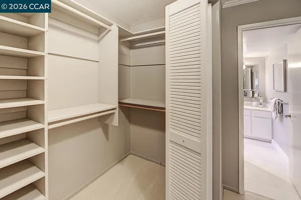 a bedroom with a bed and walk in closet