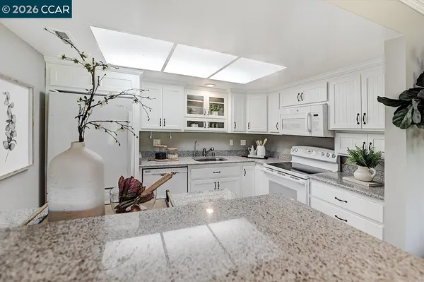 a kitchen with a sink cabinets and window