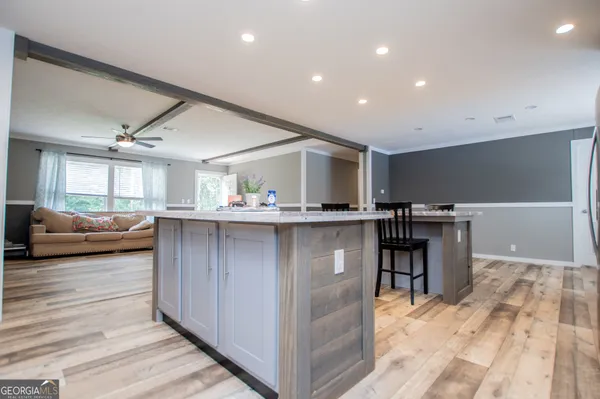 a living room with stainless steel appliances kitchen island granite countertop furniture and a kitchen view
