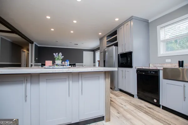 a kitchen with stainless steel appliances a refrigerator sink and microwave