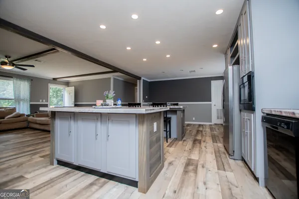 a kitchen with stainless steel appliances granite countertop a refrigerator a sink and a stove