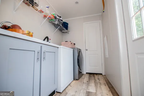 a view of storage and utility room with a window